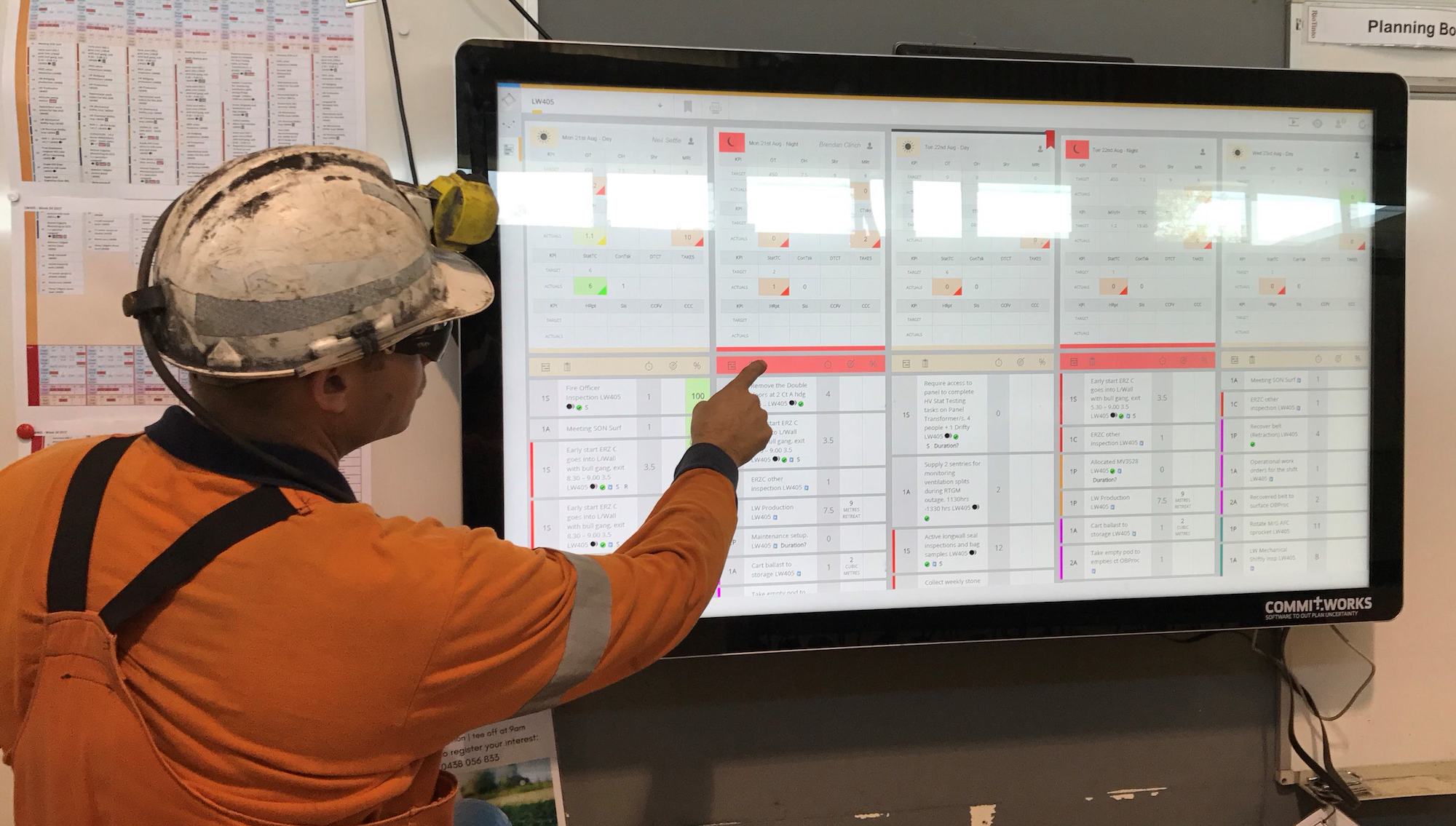 mine technician interacting with a tv touch screen